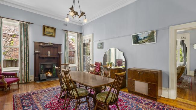 An ornate timber mantel is a feature of this dining room.