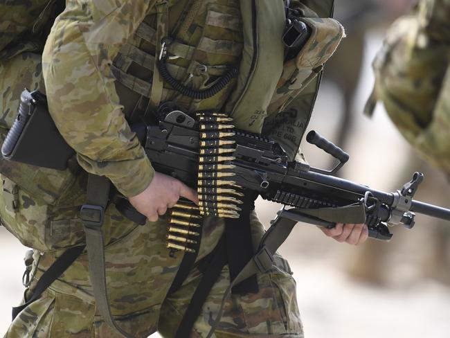 BOWEN, AUSTRALIA - JULY 22: An Australian infantry soldier from 2 RAR (Royal Australian Regiment) walks along the beach after disembarking in an amphibious operation on July 22, 2019 in Bowen, Australia. Exercise Talisman Sabre 2019 is the largest exercise that the Australian Defence Force (ADF) conducts with all four services of the United States armed forces. The biennial exercise focuses on crisis action planning and humanitarian missions, enhancing participating nations' capabilities to deal with regional contingencies and terrorism. It is the first time the NZDF has been invited to participate fully, with NZDF personnel to be working as part of a large force led by the Australians and NZDF military assets will be integrated with those of the ADF and the US armed forces. (Photo by Ian Hitchcock/Getty Images)