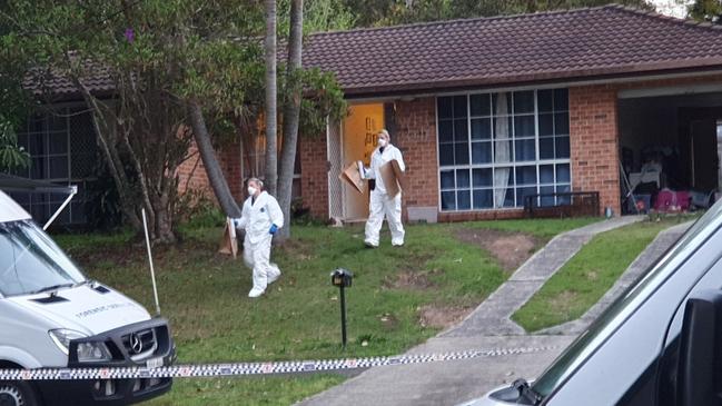 Investigators walk from the house being examined in relation to the murder of Danielle Easey. Picture: Fiona Killman