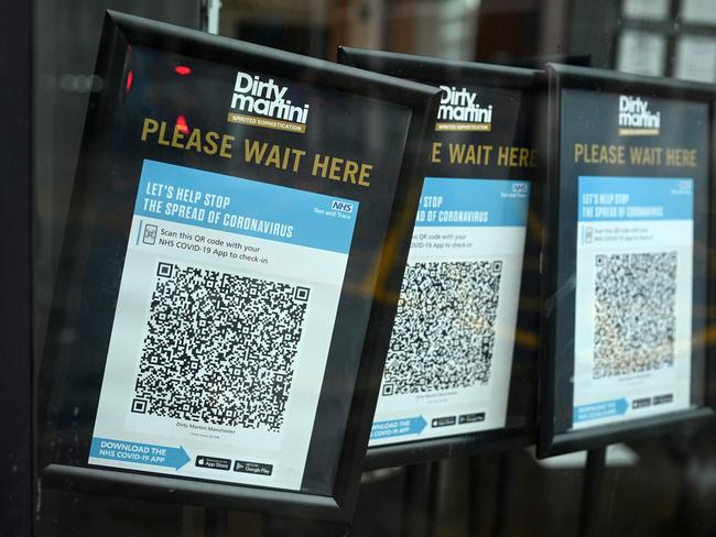 Track and trace QR codes are displayed outside a pub, in Manchester, north west England on October 13, 2020, as the number of cases of the novel coronavirus COVID-19 continue to rise. - The British government faced renewed pressure on October 13, after indications it had ignored scientific advice three weeks ago for tougher restrictions to cut rising coronavirus infections. (Photo by Oli SCARFF / AFP)