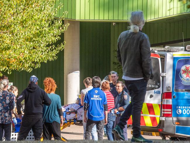 A suspected drug overdose at Richmonds Safe Injecting Room. A person has been brought out with staff assisting breathing. Saff attempt to block photos.  Police arrest and search suspected drug dealers and user around Victoria and Elizabeth street Richmond.  Picture: Jason Edwards