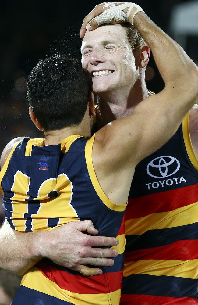 Eddie Betts hugs Sam Jacobs after the win against GWS Giants. Picture: SARAH REED