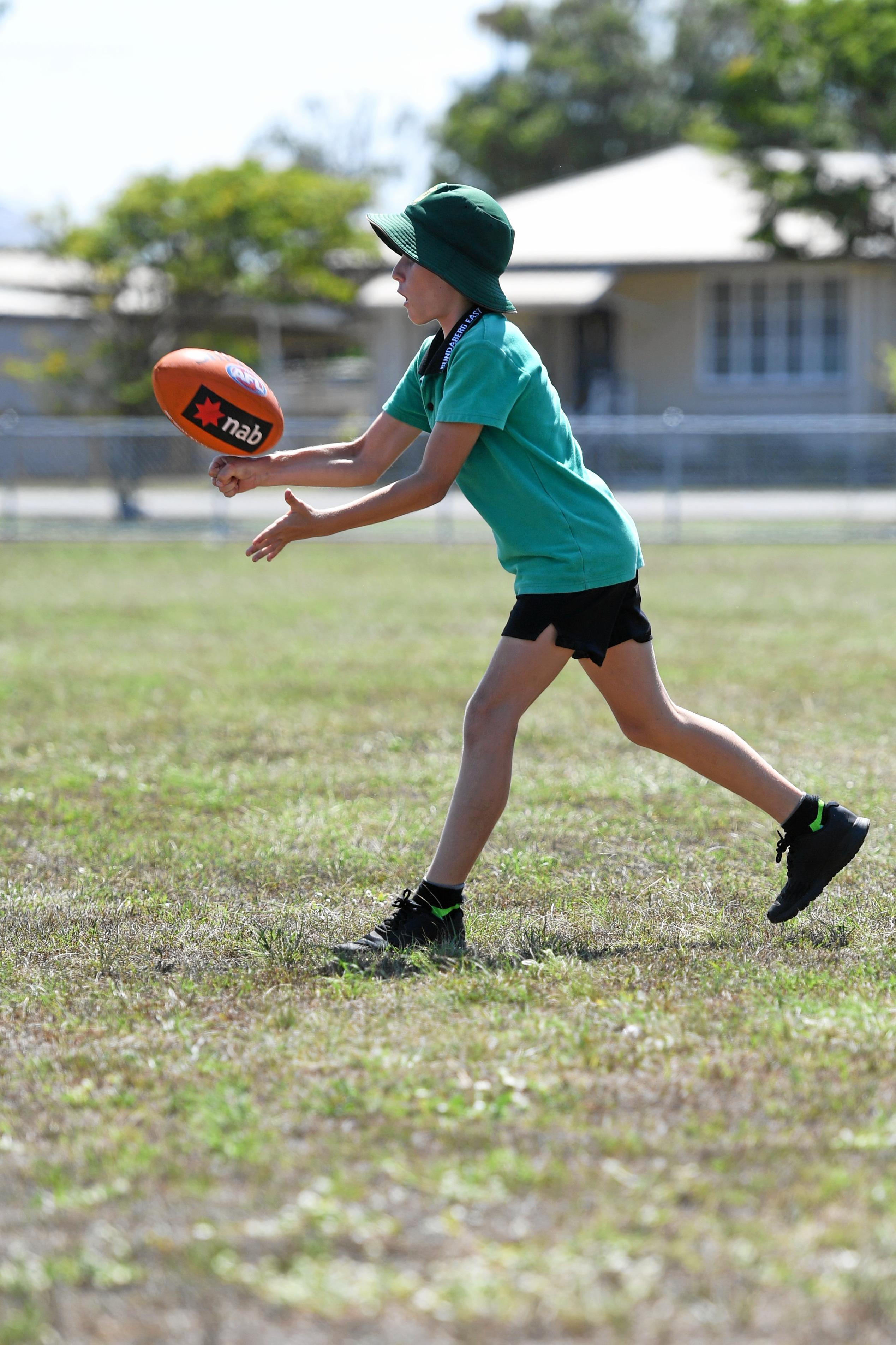 Ashton Blair hand balls to a team mate. Picture: Brian Cassidy