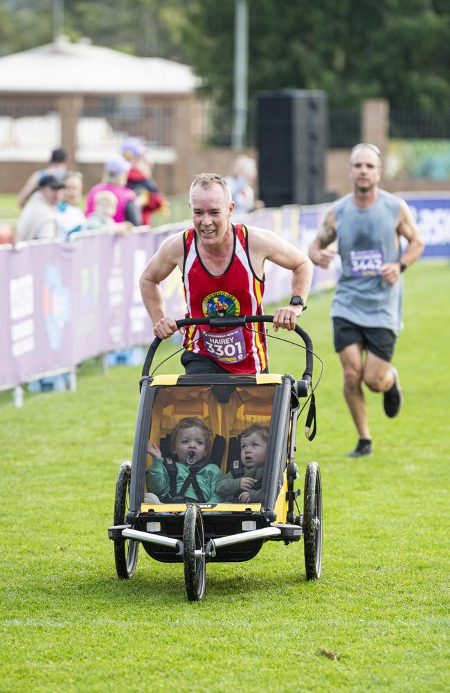 Chris Haire completes the half marathon pushing kids Evie and Joe Haire at the Toowoomba Marathon event, Sunday, May 5, 2024. Picture: Kevin Farmer