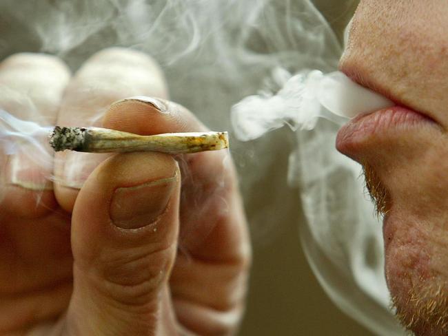 MAY 27, 2003 : A man smokes marijuana recreationally in Toronto, 27/05/03. The federal government moved to eliminate criminal penalties for simple possession of marijuana, but promised a tougher line against growers and dealers.Canada / Crime / Drug / Smoking / Cannabis / Generic / Joint