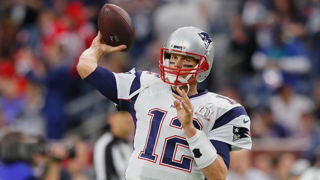 Tom Brady warms up for the game.