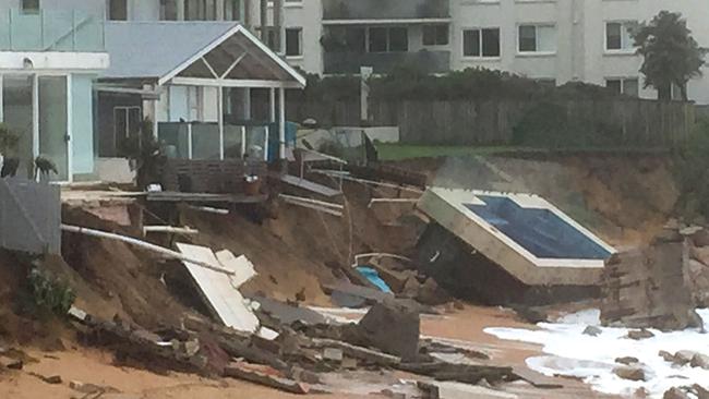 An inground pool lies on the beach next to damaged houses after a severe storm at Collaroy on Sydney's northern beaches on June 6, 2016. Picture: AFP PHOTO / BRUCE CLEMENT