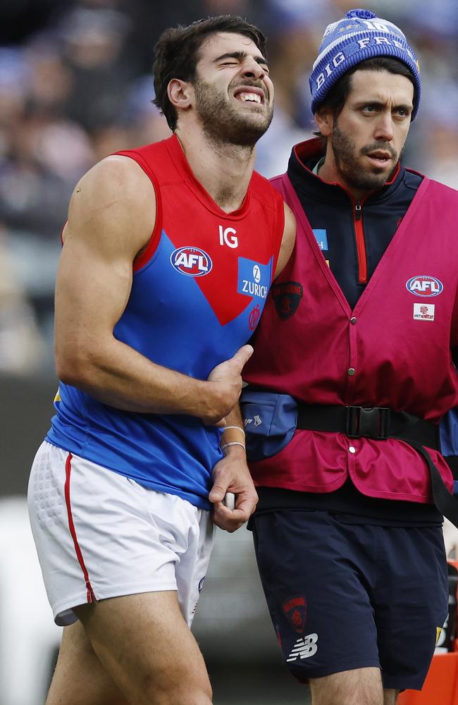 Christian Petracca of the Demons in pain after copping a Darcy Moore knee in the ribs on King’s Birthday. Picture: Michael Klein