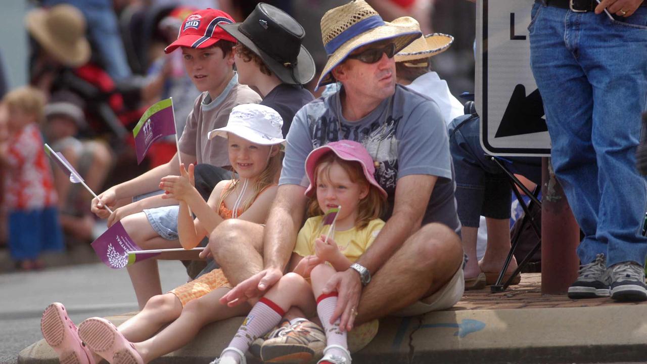 Michael Montafia with Kate 7yr and Hannah 4yr captivated by the colour during the 58th Toowoomba Carnival of Flowers street parade as it made its way through the City. Picture: David Martinelli.