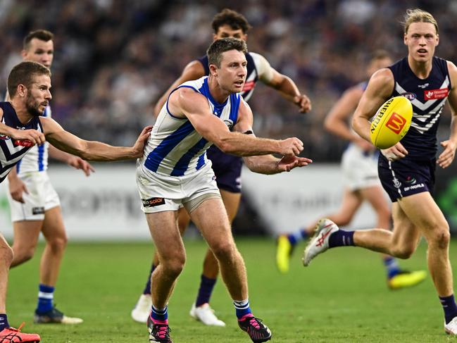 PERTH, AUSTRALIA - MARCH 25: Liam Shiels of the Kangaroos handpasses the ball during the 2023 AFL Round 02 match between the Fremantle Dockers and the North Melbourne Kangaroos at Optus Stadium on March 25, 2023 in Perth, Australia. (Photo by Daniel Carson/AFL Photos via Getty Images)