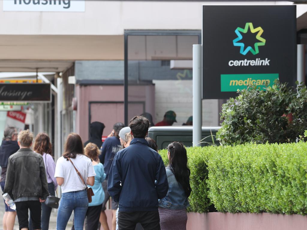 People queue outside a Centrelink. Picture: John Grainger