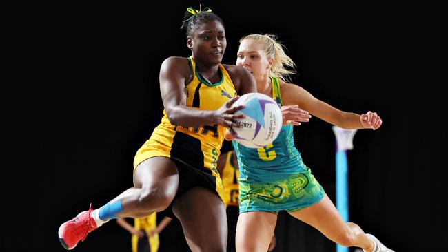 Adean Thomas of Team Jamaica (L) wins the ball ahead of Kate Moloney of Team Australia.