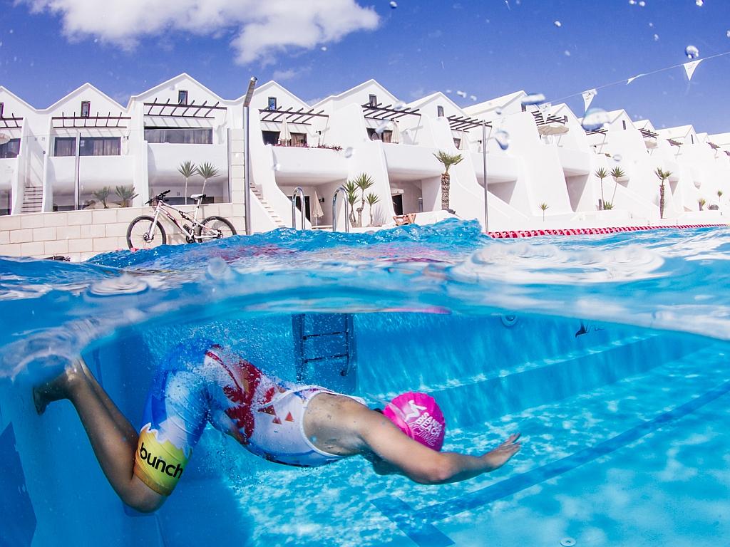 © Petra Van Borm, Belgium, Entry, Open, Split Second, 2016 Sony World Photography Awards “A young boy training hard in the pool to participate in the yearly triatlon while other kids are playing. The image is taken at Sandsbeach resort pool in Lanzarote.”