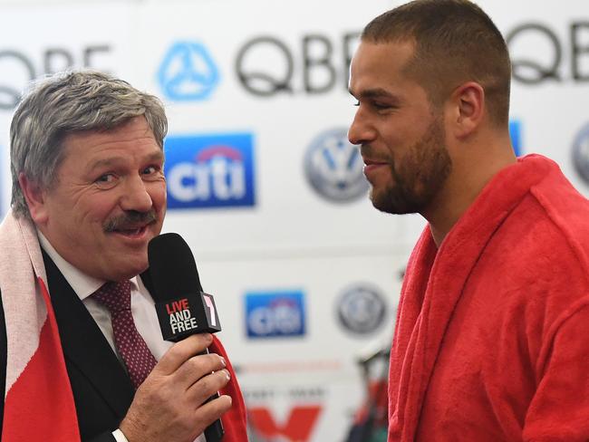 Commentator Brian Taylor (left) is seen in the Swans rooms as he interviews Lance Franklin during a roaming interview after the Round 15 AFL match between and the Melbourne Demons and the Sydney Swans at MCG in Melbourne, Friday, June 30, 2017. (AAP Image/Julian Smith) NO ARCHIVING, EDITORIAL USE ONLY