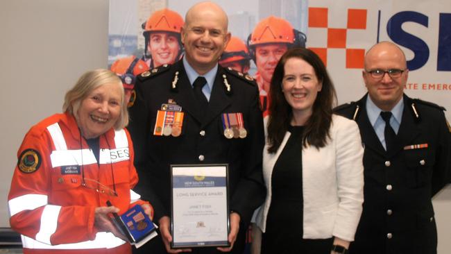 Janet Fish receives her 15-year award from SES Deputy Commissioner Greg Newton, local MP Felicity Wilson and Mosman SES Controller Vanden Helby.