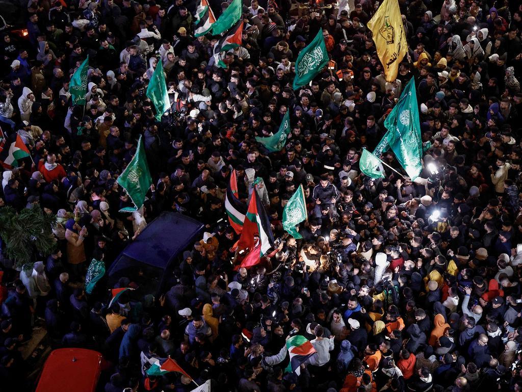 Palestinian prisoners cheer among supporters after being released from Israeli jails in exchange for hostages released by Hamas. Picture: AFP