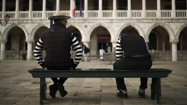 Gondoliers wait for customers near St Mark's square in Venice as tourists stay away from Italy. Picture: AP