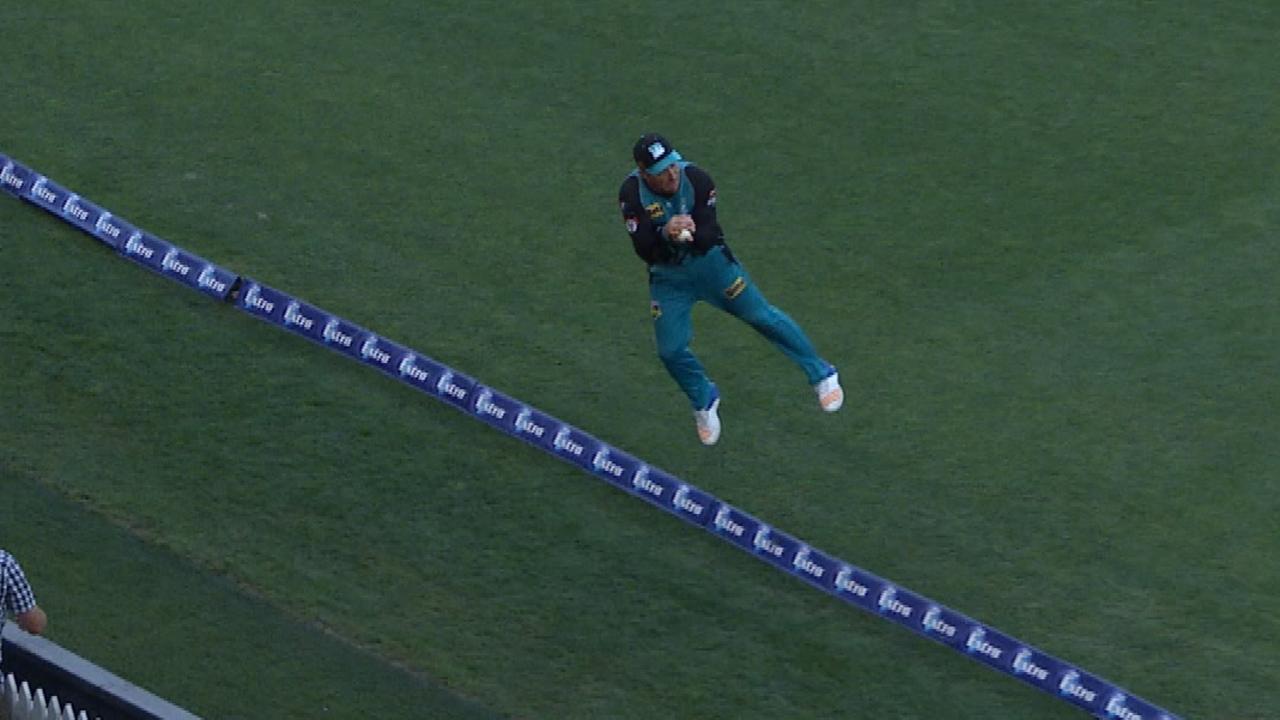 Brendon McCullum makes a catch as he heads towards the rope.