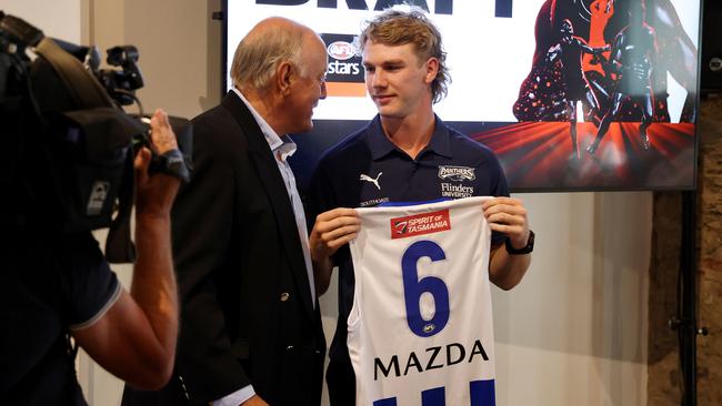 Malcolm Blight presents a guernsey to Horne-Francis after he was drafted by North Melbourne in 2021. Picture: James Elsby/AFL Photos via Getty Images