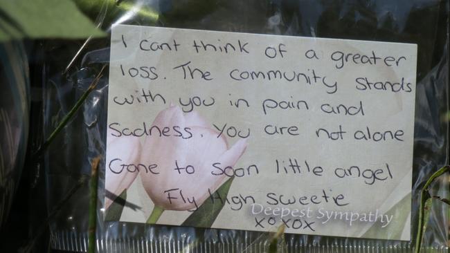 Floral tributes, cards and a soccer ball have been left on the power pole where young Archie King, 12, was killed on fagans Rd, Lisarow. Picture: Richard Noone