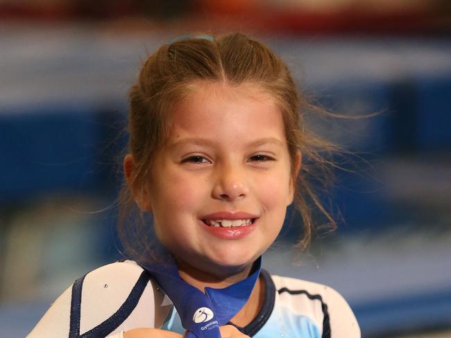 Nine year old Lauren Barter ,of Mt Druitt, poses for a photograph ,at the Sydney Gymnastics and Aquatic Centre in Rooty Hill.Lauren has been nominated for the Local Sports Star after winning gold in the Under 11's Synchronised Trampolining at Nationals.(AAP Image/Justin Sanson)