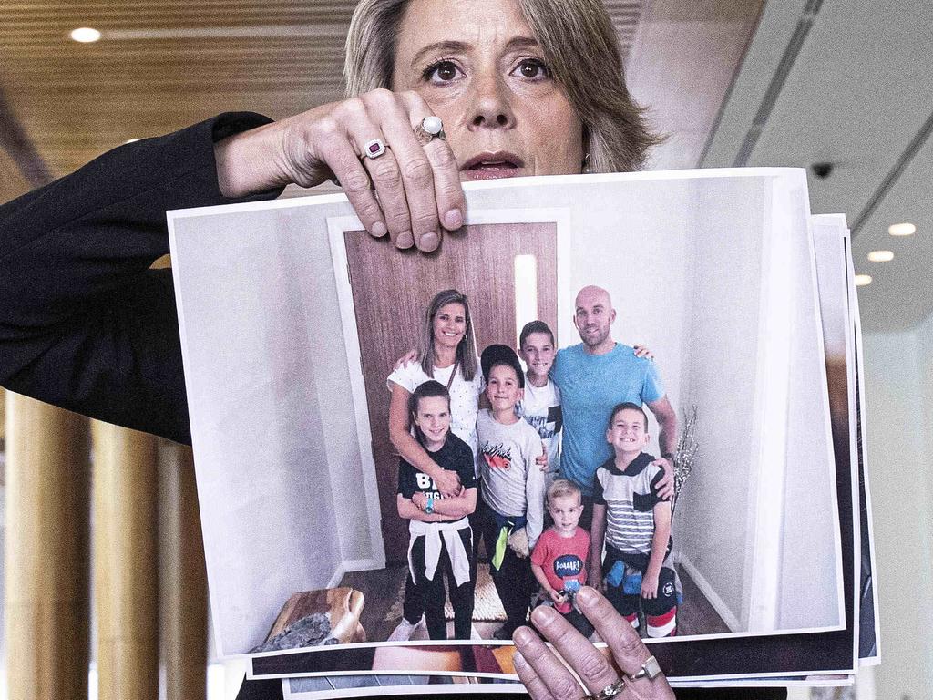 Labor Senator Kristina Keneally holds a photo of stranded Australians Deanne and Paul Vowels and their five children. Picture: NCA NewsWire/Gary Ramage