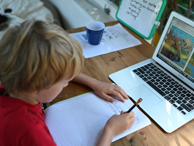 Primary school student six-year-old Oscar being home schooled on-line in Sydney, Tuesday, March 31, 2020. Many students are being kept home from school, being taught online and by their parents, New South Wales schools are still open with teachers asking students of non-essential workers be kept home in an effort to control the speed of the COVID-19 Coronavirus Pandemic. (AAP Image/Dean Lewins) NO ARCHIVING