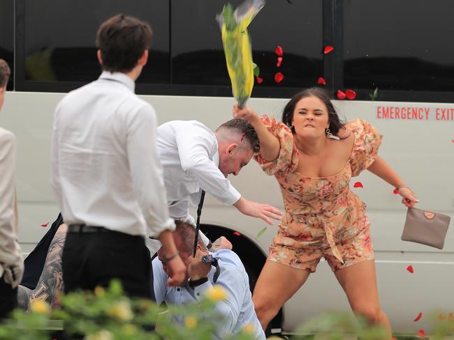 A woman tackles one of the brawlers with her bouquet. Pictures: Mark Evans/Getty Images