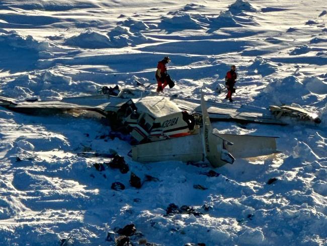 This image obtained from the US Coast Guard (USCG) on February 7, 2025, shows the remains of a plane reported missing February 6. The Bering Air Caravan was carrying nine passengers and one pilot on board. The search ended after the aircraft was located some 34 miles (55kms) southeast of Nome, Alaska. The USCG reported the three individuals were found inside and were deceased. "The remaining 7 people are believed to be inside the aircraft but are currently inaccessible due to the condition of the plane," according to a statement posted on the X of the USCG. (Photo by Handout / US Coast Guard / AFP) / RESTRICTED TO EDITORIAL USE - MANDATORY CREDIT "AFP PHOTO / US Coast Guard" - NO MARKETING NO ADVERTISING CAMPAIGNS - DISTRIBUTED AS A SERVICE TO CLIENTS