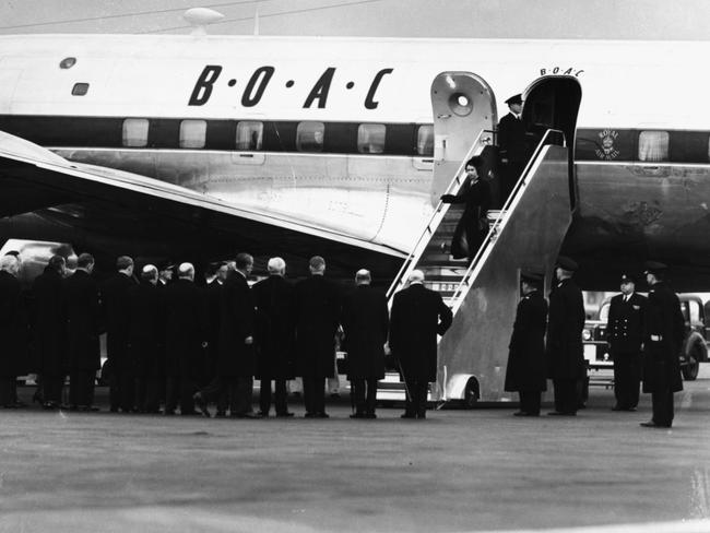 Queen Elizabeth II and Prince Philip, the Duke of Edinburgh, leaving their BOAC airplane as they return from Kenya following the death of King George VI.