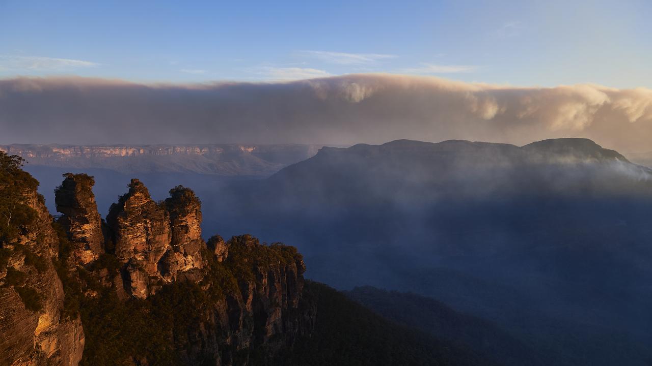 The Three Sisters as smoke from scattered bushfires covers the horizon. Picture: Brett Hemmings/Getty Images.