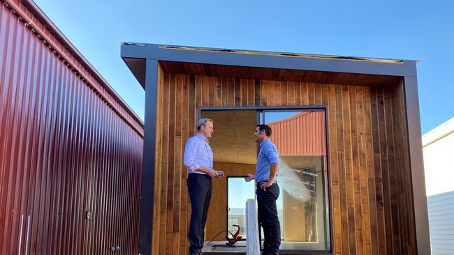 Minister for State Development, Construction and Housing Michael Ferguson inspects pods with Josh Muskett from Podmatrix in Cambridge, Tasmania on Tuesday 29 June, 2021.