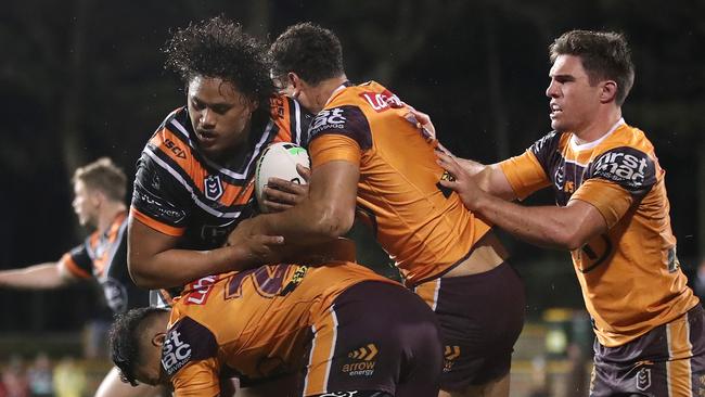 Luciano Leilua is wrapped up the Broncos’ defence. Picture: Getty Images