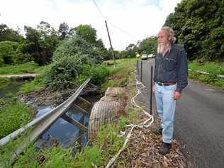 WAITING, WAITING: Concerned resident Murray Ings at the bridge on Mountain Top Road near Jiggi where the barrier was washed away by the rains in March 2017. Picture: Marc Stapelberg