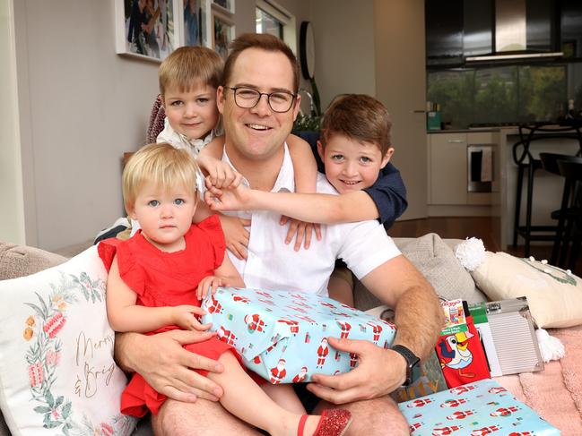 SMARTdaily Christmas gifts for dad. Dad Joseph Du Rieu with Christmas presents from his kids Reuben 4, Rachel 2 and Dominic 6 at home.                      Picture: David Caird