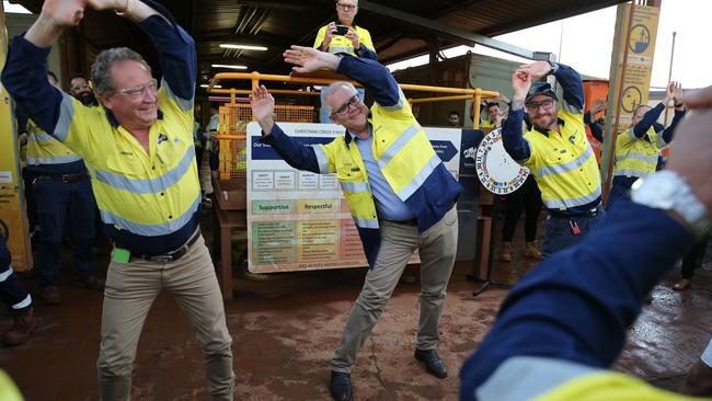 Prime Minister Scott Morrison joins Fortescue Metals Group's CEO Andrew Forrest in morning stretches during a tour of the Christmas Creek mining operations last week. Picture: Getty