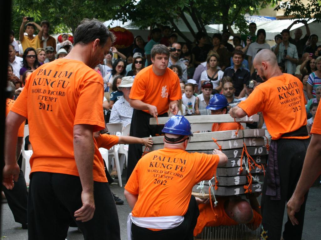 Neal Hardy - Heaviest concrete block break on a bed of nails, 15 blocks weighing 774.99 kg (1708 lb 8 oz) placed on his chest and broken at Petrie Plaza in Canberra, Australia. Picture: Supplied