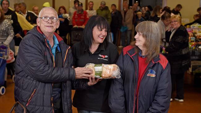 Enam Habim, at her Elizabeth food market with Cyril Lane and Faye Jones who met at the market and are now married. Picture: Naomi Jellicoe Jellicoe