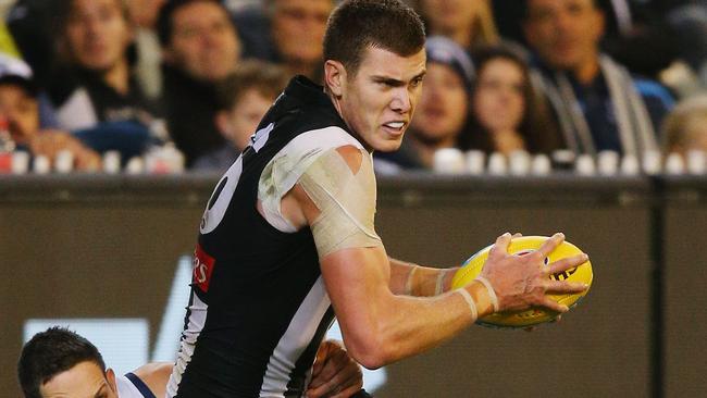 Mason Cox is tackled by Harry Taylor.