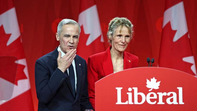 Mark Carney alongside his wife Diana gestures at supporters after being elected. Picture; AFP