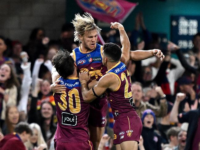 BRISBANE, AUSTRALIA - JUNE 28: Kai Lohmann of the Lions celebrates with team mates after kicking a goal during the round 16 AFL match between Brisbane Lions and Melbourne Demons at The Gabba, on June 28, 2024, in Brisbane, Australia. (Photo by Bradley Kanaris/Getty Images)