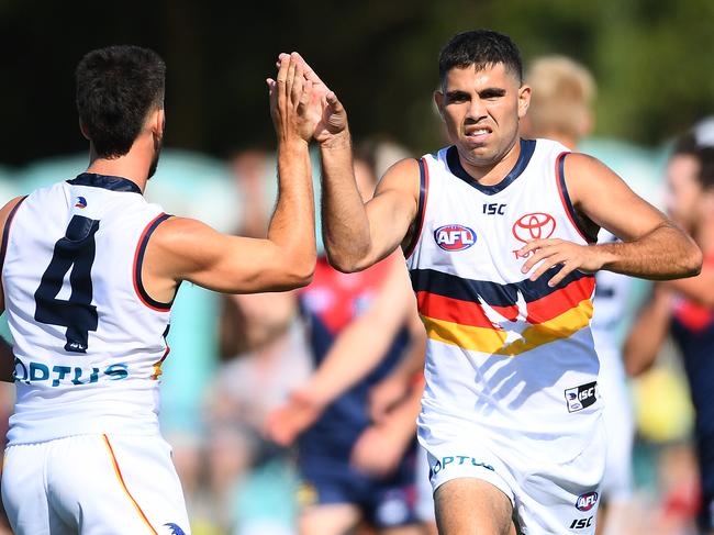 MELBOURNE, AUSTRALIA - FEBRUARY 22: Tyson Stengle of the Crows is congratulated by team mates after kicking a goal during the 2020 Marsh Community AFL Series match between the Melbourne Demons and the Adelaide Crows at Casey Fields on February 22, 2020 in Melbourne, Australia. (Photo by Quinn Rooney/Getty Images)