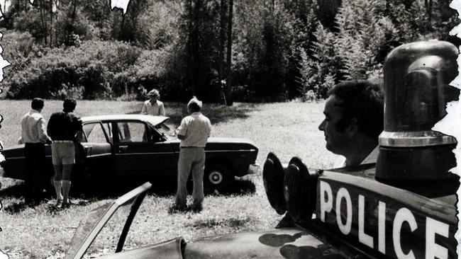 February 3, 1980: Murder scene at Tweed Heads West, NSW. Detectives from Lismore and Sydney examine the car that was found beside the body of victim Jeffrey Parkinson. The suspect is known as the balaclava killer and rapist.