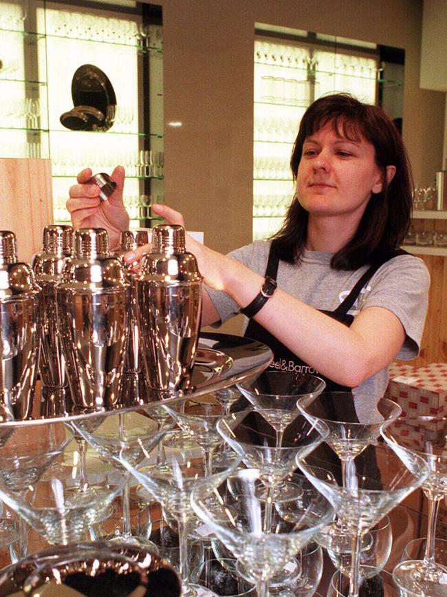 Mary Kotses, then-director of Wheel &amp; Barrow homewares store, prepares for an opening in 1998.