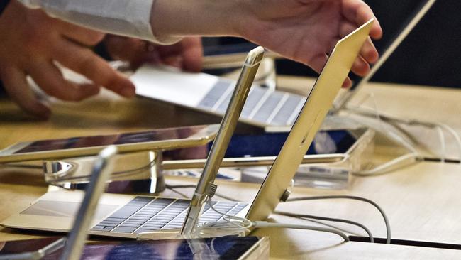 New Mac ... People inspect Apple’s new MacBook in New York. (AP Photo/Bebeto Matthews)