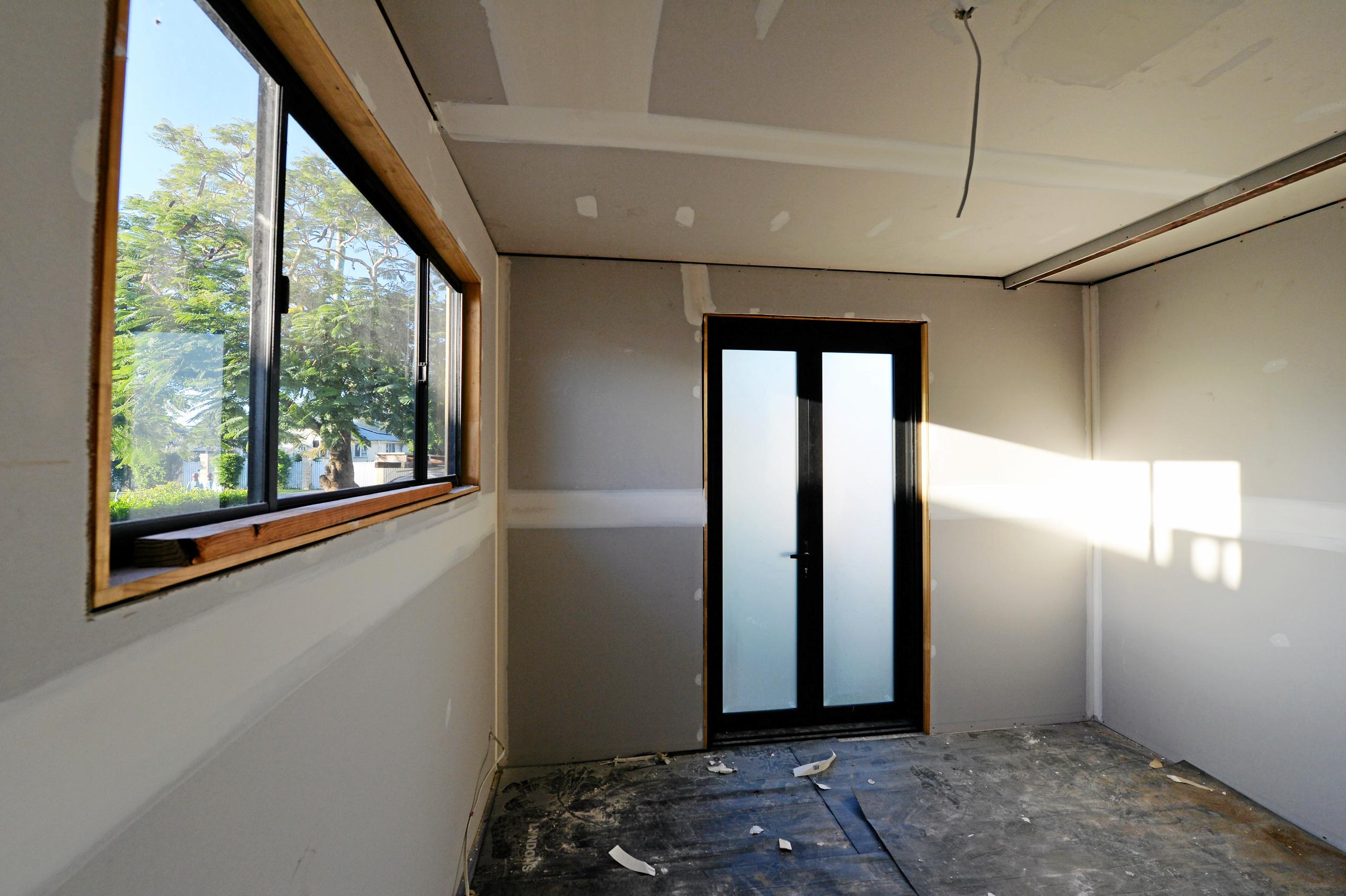 Mackay house-flippers Madison Strutynski and Michael Cotter at their Hunter St, West Mackay property. Picture: Stuart Quinn