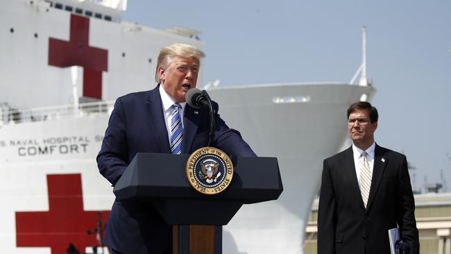 Donald Trump and Defence Secretary Mark Esper bid farewell to hospital ship USNS Comfort at Naval Station Norfolk, Virginia, on Sunday. Picture: AP