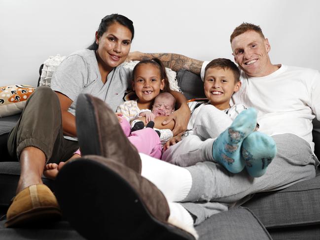 Emma MacNeill and Mitch Robinson from the Brisbane Lions with Charli Robinson, 6, Chance Robinson, 8, and Maali Robinson, 2weeks with their trackpants for Tracky Dack Day, Brisbane 27th of May 2022. (Image/Josh Woning)