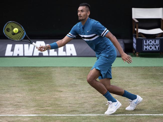 Nick Kyrgios returns a ball during the semifinal tennis match against Roger Federer during the ATP Mercedes Cup in Stuttgart, Saturday June 16, 2018. (Marijan Murat/dpa via AP)