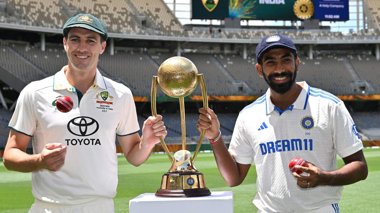 Pat Cummins and Indian captain Jasprit Bumrah with the Border/Gavaskar trophy at Optus Stadium in Perth. Picture: Saeed Khan / AFP